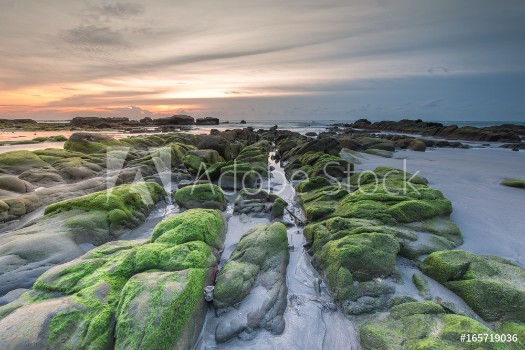 Picture of Colorful sunset with natural coastal rocks Image contain soft focus due to long exposure